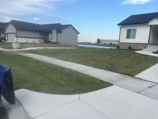 A trimmed lawn with clean edges along a sidewalk