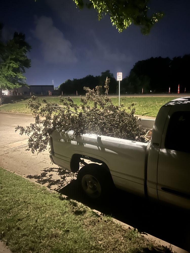 A pickup truck loaded with yard debris, from the Adonis Lawn Care Yelp listing